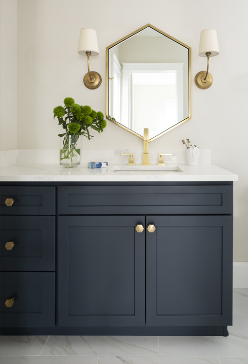 navy blue bath with brass hardware and fixtures
